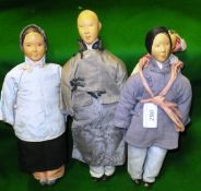 A collection of four early 20th Century Chinese dolls with painted and carved wooden heads and