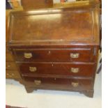 A mahogany three drawer bureau on bracket feet with brass handles and escutcheons