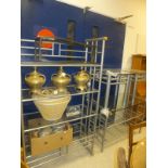 A steel and glass four section open display case, two matching side tables, a further table,