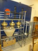 A steel and glass four section open display case, two matching side tables, a further table,