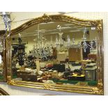 An overmantel mirror of gilt effect and mirrored frame