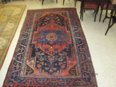 A Caucasian rug, the central medallion in red, blue,