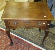 A 19th Century oak single drawer side table on cabriole legs to pad feet and a baluster shaped