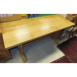 A rectangular oak dining table on trestle style supports