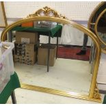 A gilt framed overmantel mirror with arched top and carved decoration