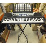 A Yamaha EZ-150 keyboard and stand,