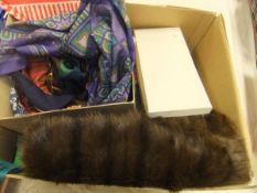 A box containing a quantity of camel coloured coats,
