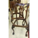 A pair of Victorian mahogany framed hall chairs with carved decoration to the back splat,