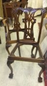 A pair of Victorian mahogany framed hall chairs with carved decoration to the back splat,