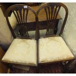 A pair of early 19th Century style mahogany framed dining chairs in the Hepplewhite manner