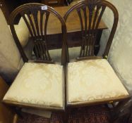 A pair of early 19th Century style mahogany framed dining chairs in the Hepplewhite manner