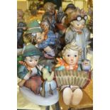 A collection of ten Goebel Hummel figures to include "Let's sing", "Boy with bird upon his feet",
