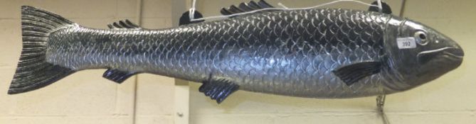 A painted metal shop sign as a salmon