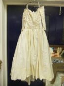 A 1980's silk wedding dress with beaded decoration (purportedly by Emanuel)