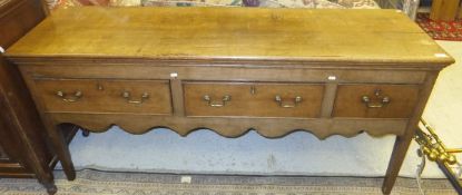 An early 19th Century oak dresser, the plank top over three frieze drawers,