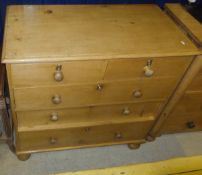 A Victorian pine chest of two short and three long drawers, with wooden handles,