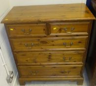 A modern pine chest of two short over three long drawers on bracket feet