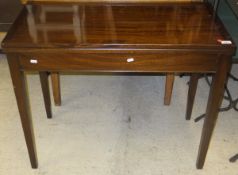 An early to mid 20th Century mahogany fold over card table on square tapered legs