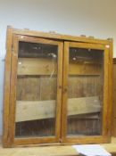 A Victorian pine two door display cabinet with three adjustable shelves