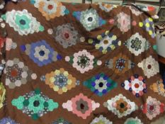 A box containing a late 1970's patchwork quilt,