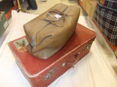 A vintage red leather suitcase stamped "San Kong Mark made in Shanghai",