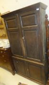 A 19th Century oak cupboard, the upper section with two twin panelled doors on a base with two