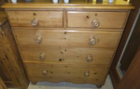 A Victorian pine chest of two short and three long graduated drawers,