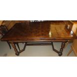 An oak parquetry inlaid draw leaf dining table with turned legs to stretchered base