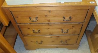A pitch pine chest of three long drawers on bracket feet