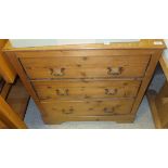 A pitch pine chest of three long drawers on bracket feet