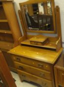 An early 20th Century satin walnut bedroom suite comprising single mirrored door wardrobe over a