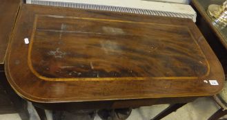 A 19th Century mahogany fold-over card table on square tapered legs to spade feet