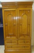 A Victorian light oak linen press with moulded cornice above two doors enclosing four linen press