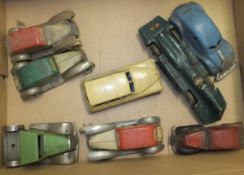 A collection of eight early 20th Century tin plate toy cars including a Schuco saloon car,