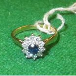 An 18 carat gold mounted sapphire and diamond cluster ring, the centre stone approx 0.