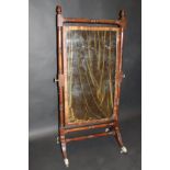 A 19th Century mahogany rectangular cheval mirror on turned frame with acorn finials and