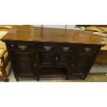 A Victorian mahogany dresser base with two short and one long drawer above cupboard doors  and an