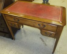 A 20th Century yew wood desk with red leather inset top,