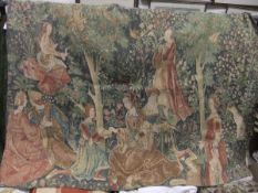 A needlework wall hanging depicting figures in Medieval dress in a woodland (bought from Liberty's