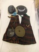 A box containing two kilts together with a beret bearing cap badge inscribed "Cameron" and leather