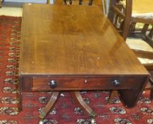 A Regency mahogany drop leaf Pembroke table on centre pedestal to splayed quadruped base,