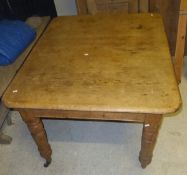 A Victorian pine extending dining table, with extra leaf,