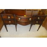 A Regency mahogany serpentine fronted sideboard with various drawers,