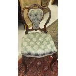 Two Victorian walnut salon chairs with button back upholstered seat and back in green ground