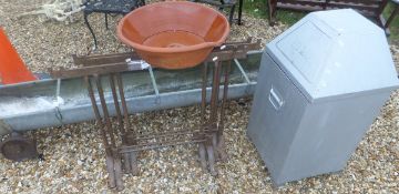 A galvanised steel animal feeder, four builder's trestles,