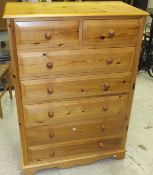 A modern pine chest of two short and five long graduated drawers