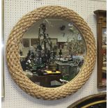 A woven rush framed circular wall mirror