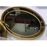 Two similar circa 1900 giltwood and gesso framed multi-plate oval wall mirrors