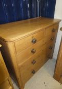 A Victorian pine chest of two short and three long drawers, the top with rounded corners,