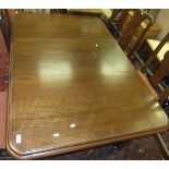 A Victorian mahogany rounded rectangular extending dining table on turned and reeded legs to